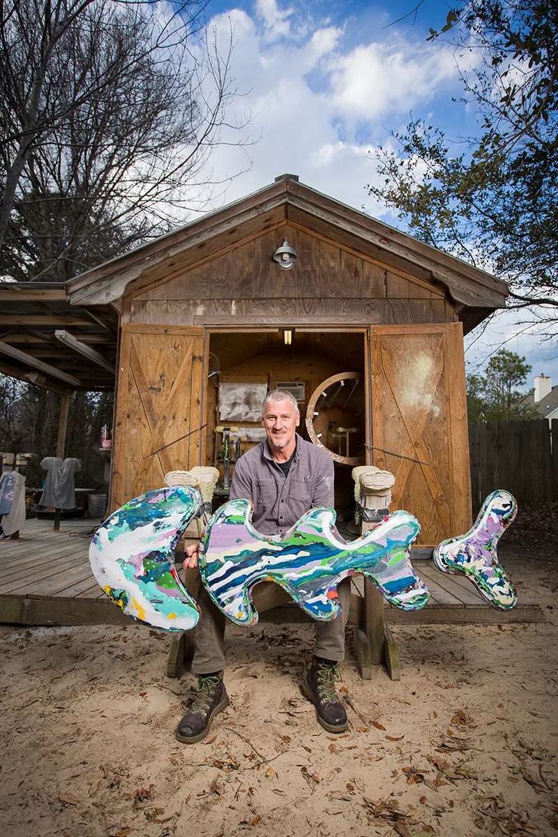Outer Banks artist Mike Rowe with an original fish sculpture