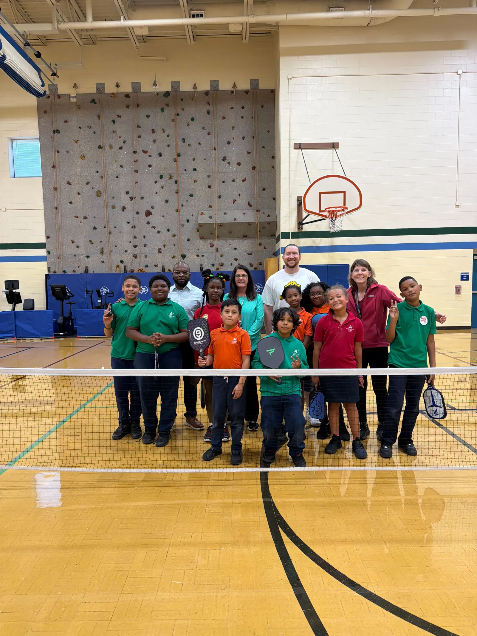 Youth pickleball camp group gathered on the court
